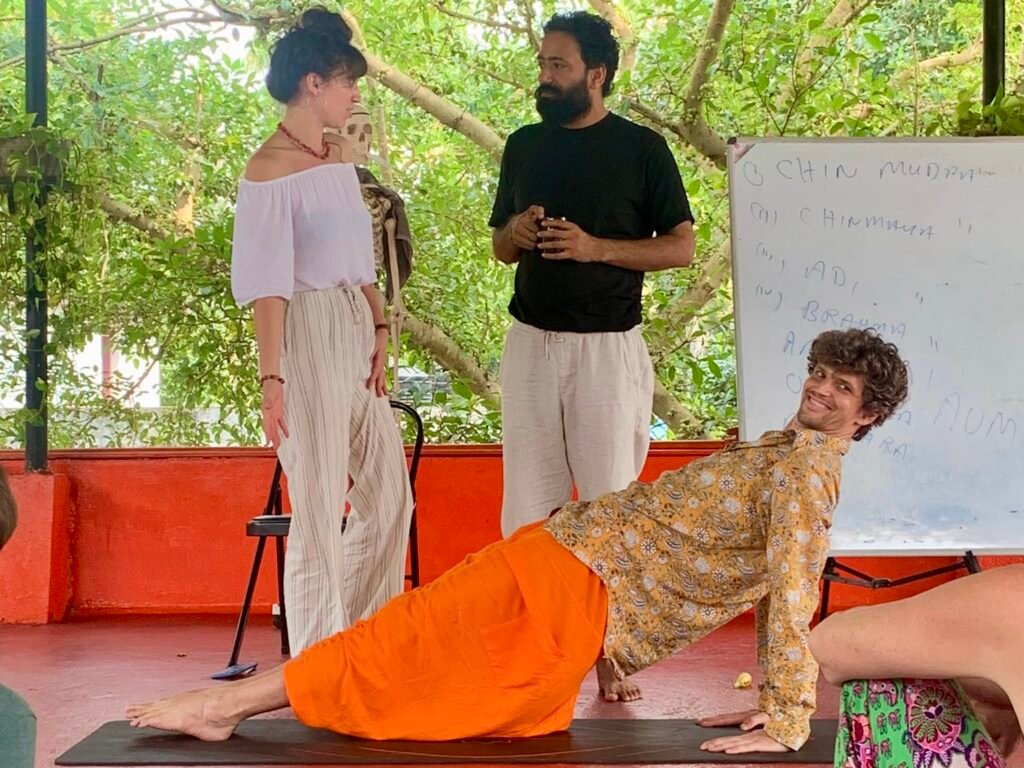 hatha-yoga-adjustment-classroom-scene-devvrat-yoga-sangha-kerala